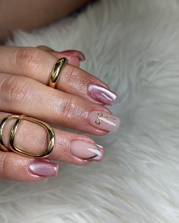 Pink chrome almond nails with a gold ring