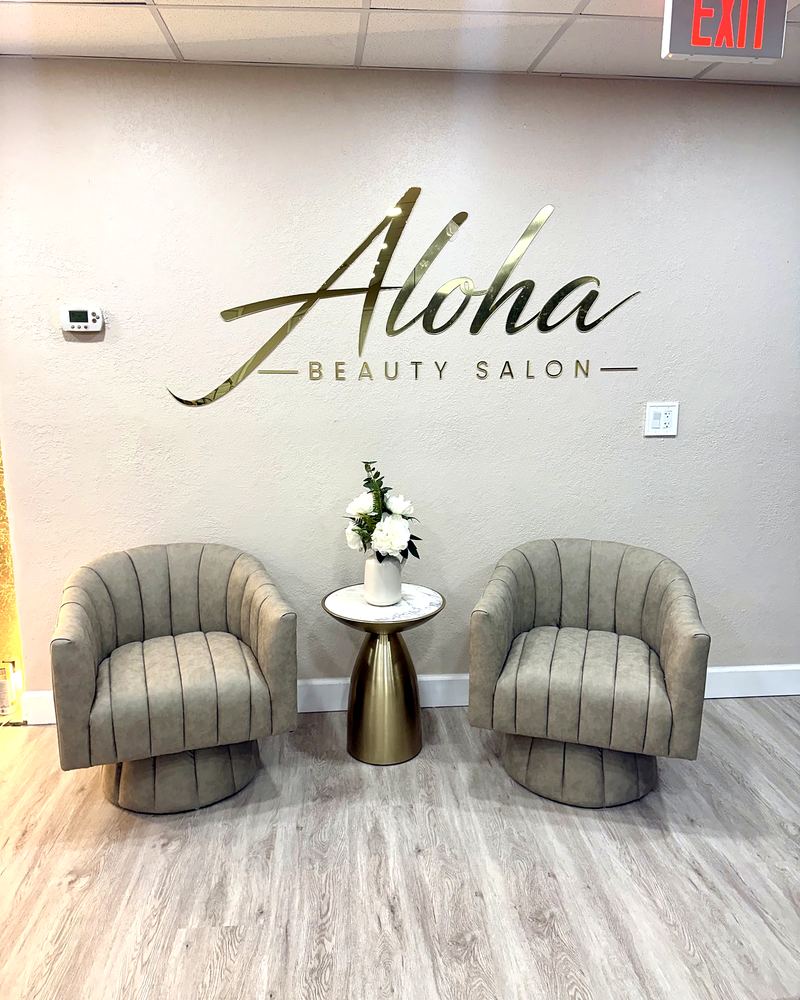 Aloha Beauty Salon reception with gold logo and two armchairs